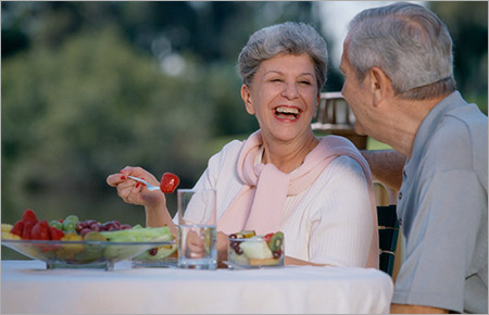 senior couple eating together outside
